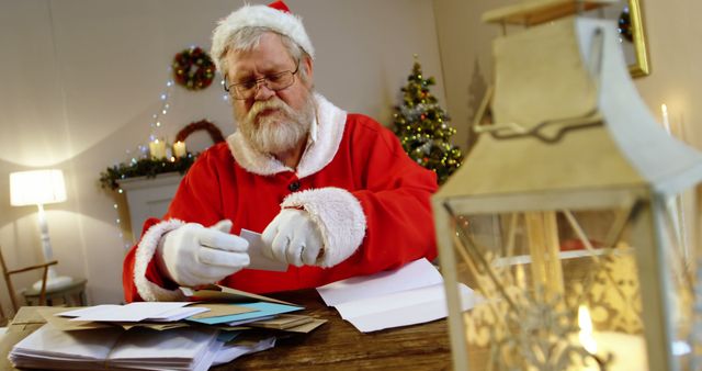 Santa Claus Reading Christmas Letters in Festive Room - Download Free Stock Images Pikwizard.com