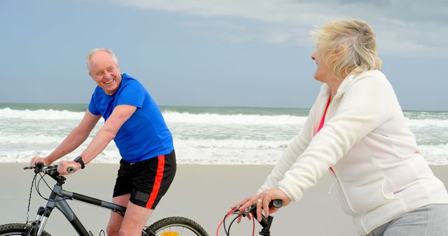 Senior Couple Enjoying Bike Ride on Beach - Download Free Stock Images Pikwizard.com