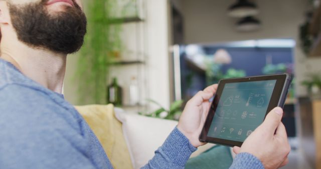 Man Using Smart Home Device Tablet for Home Automation - Download Free Stock Images Pikwizard.com