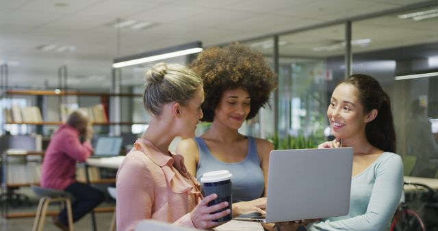 Three Women in Modern Office Collaborating on Laptop - Download Free Stock Images Pikwizard.com