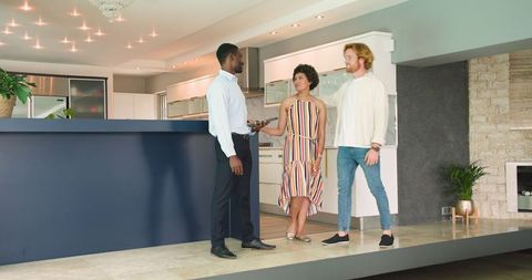 Couple discussing home purchase with real estate agent