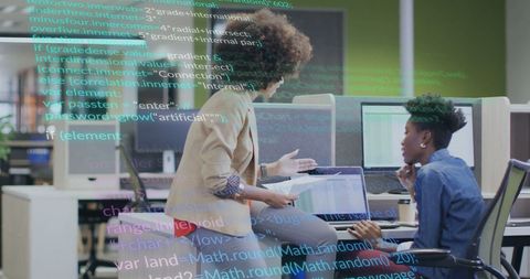 Female Colleagues Collaborating on Data Processing Project in Modern Office