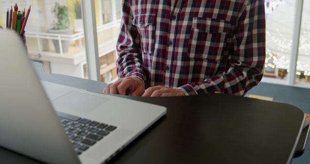 Person Wearing Checkered Shirt Typing on Laptop at Standing Desk - Download Free Stock Images Pikwizard.com