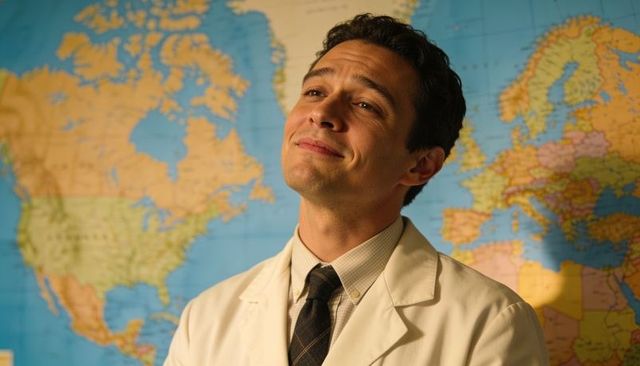 Confident male educator standing in lab coat and tie smiling presenting world map backdrop