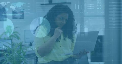 Businesswoman Analyzing Data on Laptop in Modern Office Setting