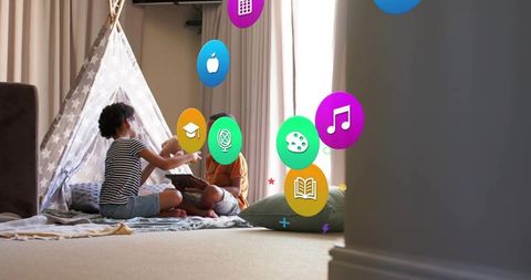 Kids sharing tablet and stuffed toy by teepee in cozy living room, siblings bonding
