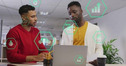 Colleagues discussing sustainability analytics over laptop with green overlay icons