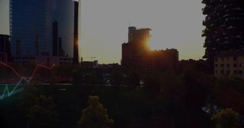 Sun-flaring skyline over urban park with curved glass tower and vertical forest highrise