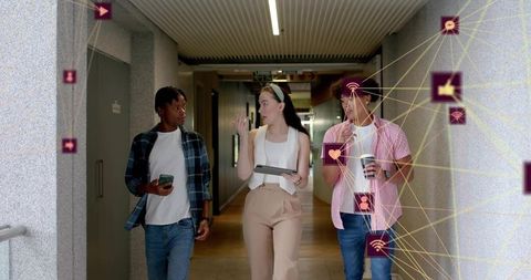 Young team walking and discussing augmented reality collaboration in office corridor