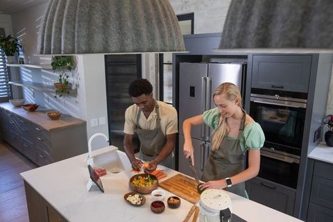 Diverse Friends Cooking Vegetables in Modern Kitchen