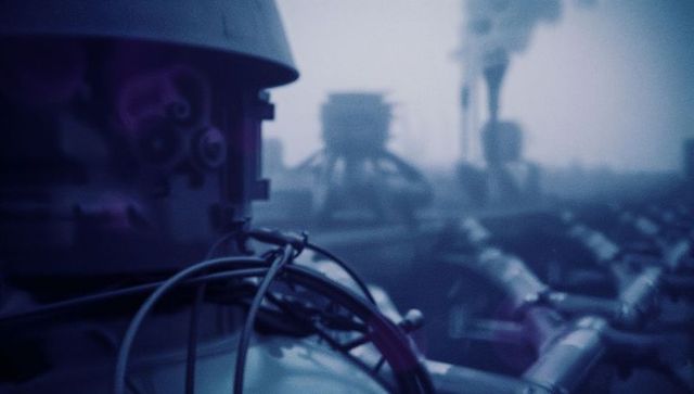 Industrial refinery with metal tanks and smoke production