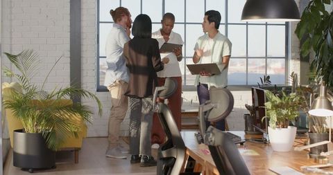 Dynamic Business Team Collaborating in Sunlit Modern Office