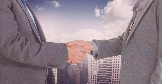 Depicts a professional handshake between two business people with a cityscape background, symbolizing cooperation and successful partnership in a corporate environment. Suitable for use in marketing materials, business presentations, advertisements, and articles focused on business agreements, teamwork, and professional success.