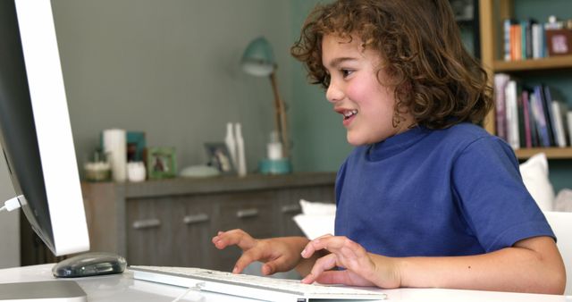 Happy Child Using Computer at Home Workspace - Download Free Stock Photos Pikwizard.com