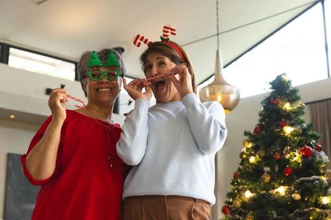 Joyful Senior Women Celebrating Christmas with Candy Canes