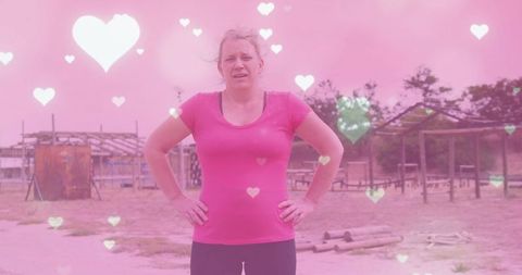 Fit woman resting at outdoor obstacle course with heart filter