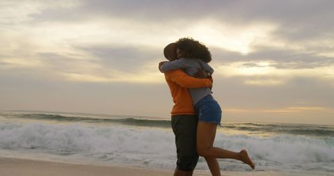 Serene Beach Embrace of Joyful African American Couple at Sunset
