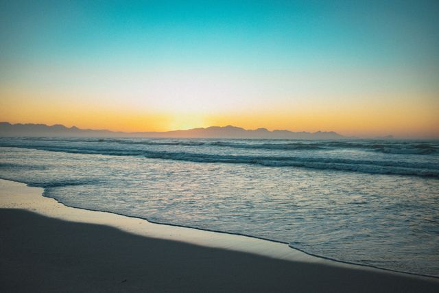 Serene Sunset Over Calm Ocean Waves - Download Free Stock Photos Pikwizard.com
