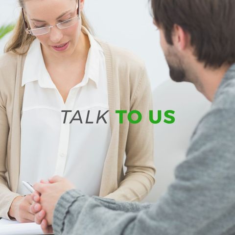 Counselor providing support across from young male client