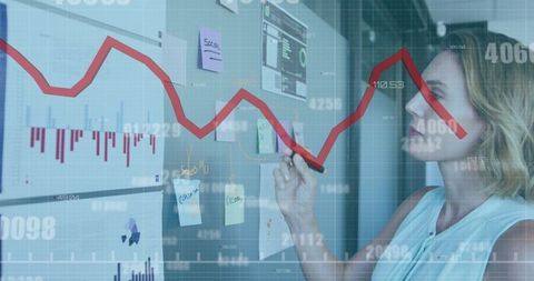 Businesswoman analyzing financial data and charts