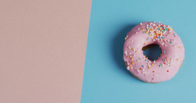 Pink Frosted Donut with Sprinkles on Two-Tone Background - Download Free Stock Images Pikwizard.com