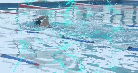 Male swimmer competing in race at indoor pool with lane dividers