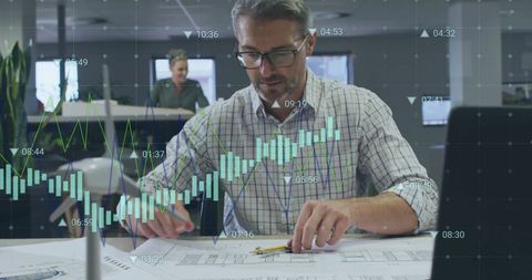 Businessman analyzing financial data charts in modern office