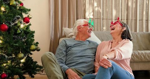 Elderly Couple Enjoying Christmas with Reindeer Glasses