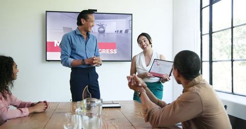 Diverse Team Celebrates Achievements in Office Meeting