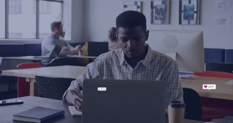 Focused Professional Typing on Laptop at Modern Office