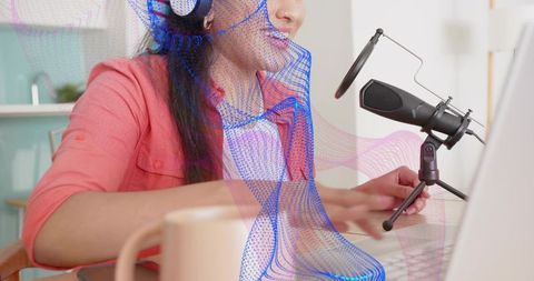 Indian woman podcasting at home desk with professional microphone and laptop