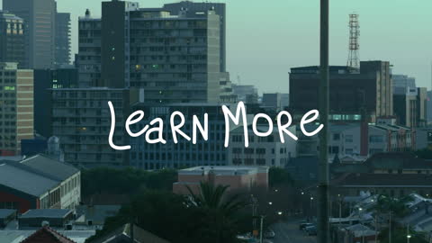 Motivational Learn More Text with Urban Cityscape Background