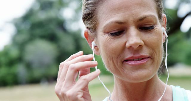 Active Middle-Aged Woman Enjoying Music Outdoors - Download Free Stock Images Pikwizard.com