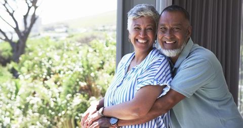 Joyful Mature Couple Embracing Outdoors in a Sunny Garden Setting - Download Free Stock Images Pikwizard.com