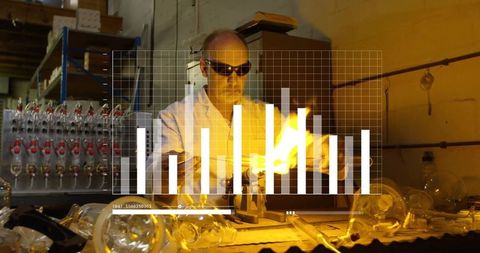 Goggled Glassblower Creating Art Using Torch and Precision Tools