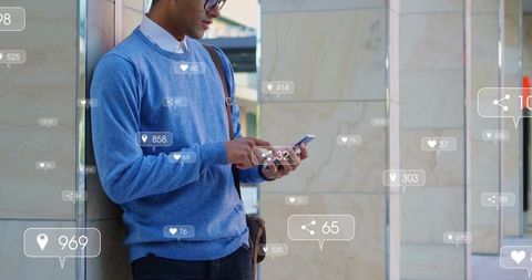 Young man leaning on column checking smartphone with social media notification overlays