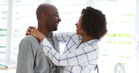 Joyful African American Couple Embracing in Bright Space - Download Free Stock Images Pikwizard.com