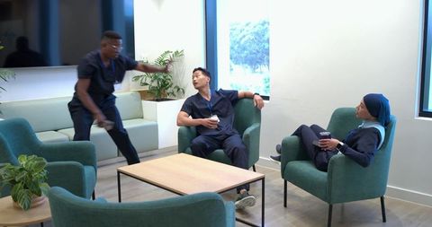Healthcare team taking coffee break in bright staff lounge
