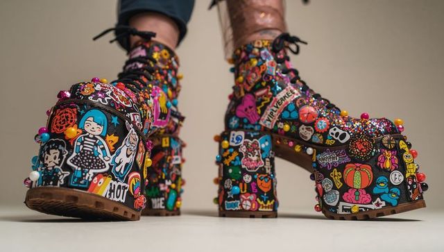 Showcasing sticker-covered platform lace-up boots featuring beads, charms and glitter