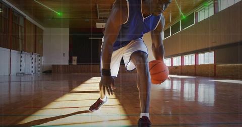 Male Athlete Dribbling Basketball on Indoor Court