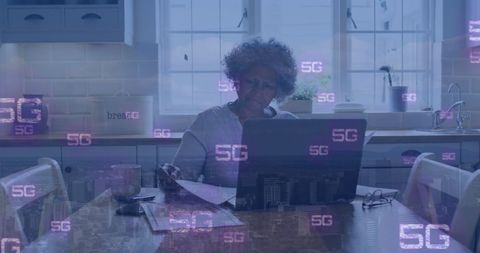 Senior African American Woman Using Laptop Amid 5G Digital Overlays