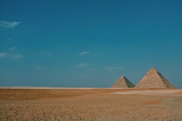 Historic Egyptian Pyramids in Vast Desert under Clear Blue Sky - Download Free Stock Photos Pikwizard.com
