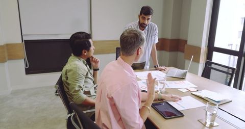 Diverse Team Collaborating on Business Plan in Modern Office