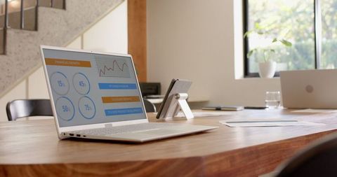 Modern Workspace with Financial Analysis on Laptop