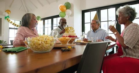 Senior Friends Celebrating 80th Birthday Party with Toast