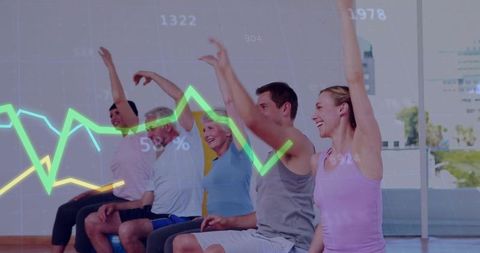 Diverse adults raising arms on stability balls exercising with fitness data overlay
