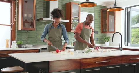 Couple enjoying cooking together in modern home kitchen