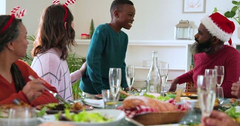 Diverse Family Celebrating Christmas Dinner in Festive Setting