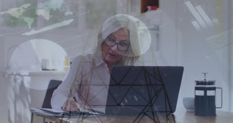 Senior Entrepreneur Analyzing Business Data at Desk
