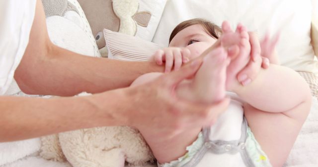 Parent Blurred Handling Cute Baby in Cozy Bed with Stuffed Bear - Download Free Stock Images Pikwizard.com